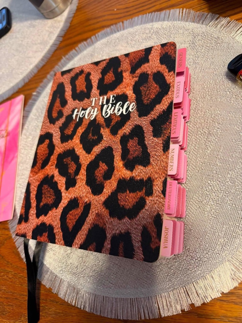 Animal print Canvas Bible with pink Bible tabs in a customer home